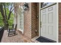 Inviting front porch with rocking chairs, brick flooring, and decorative windows at 604 Timm Valley Ne Rd # A, Atlanta, GA 30305