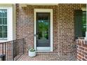 Welcoming front porch with a glass door and classic brick facade at 1393 Kings Park Nw Dr, Kennesaw, GA 30152