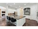 Bright kitchen with large island, stainless steel appliances, dark backsplash and hardwood floors at 1393 Kings Park Nw Dr, Kennesaw, GA 30152