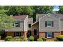Charming two-story townhome featuring neutral siding, brick accents, and well-maintained landscaping at 24 Dunwoody Springs Dr, Atlanta, GA 30328