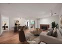 Staged living room with neutral walls, fireplace, wood floors, and ample natural light at 24 Dunwoody Springs Dr, Atlanta, GA 30328