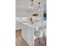 Charming kitchen with marble waterfall island, stainless appliances, pendant lights, and white shaker cabinets at 300 Johnson Ferry Ne Rd # A706, Atlanta, GA 30328