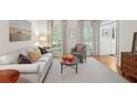 Inviting living room with neutral tones, large windows, and classic furnishings at 680 Parkside Trl, Marietta, GA 30064