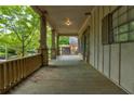 Inviting front porch with wooden railing, stone pillars, and ample space for relaxing and enjoying the outdoors at , Atlanta, GA 30310