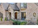 Brick and stone home showing arched entry, leaded glass window and elegant details at 1031 Eulalia Ne Rd, Atlanta, GA 30319