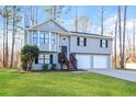 Charming two-story home featuring a two-car garage and a well-maintained lawn at 2235 Azalea Dr, Loganville, GA 30052