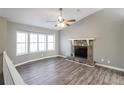 Bright living room with stone fireplace, vaulted ceilings, and large windows; light gray walls at 2235 Azalea Dr, Loganville, GA 30052