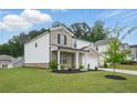 Charming two-story home with a brick and white facade, a well-manicured lawn, and an attached two-car garage at 4477 Bethany Manor Dr, Snellville, GA 30039