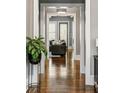 Hallway with polished hardwood floors, neutral walls, and views into the living room beyond at 970 N Ormewood Park Se Dr, Atlanta, GA 30316