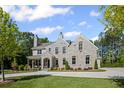Beautiful stone home with lush front lawn, landscaped shrubbery, and charming front porch at 126 Owens Mill Pl, Canton, GA 30115