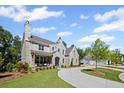 Elegant stone home with a welcoming front porch and beautiful landscaping at 126 Owens Mill Pl, Canton, GA 30115