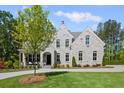 Charming stone facade home featuring manicured lawn and inviting front porch seating at 126 Owens Mill Pl, Canton, GA 30115