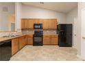 Bright kitchen features wood cabinets, black appliances, and plenty of counter space at 7161 Boulder Pass, Union City, GA 30291