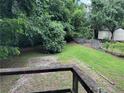 Backyard featuring grassy area, mature trees and vegetation, storage sheds and partial fencing at 1142 Pluma Se Dr, Atlanta, GA 30316