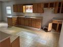 Kitchen featuring wood cabinets, laminate countertops, and unique tile flooring at 1142 Pluma Se Dr, Atlanta, GA 30316