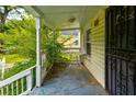 Relaxing front porch featuring a table for outdoor seating and wrought iron security door at 246 Stafford Nw St, Atlanta, GA 30314