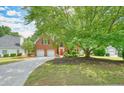 Beautiful two-story brick home with a large front yard featuring mature trees and landscaping at 510 Morning Mist Ct, Alpharetta, GA 30022