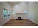 Bright living room with vaulted ceilings, wood floors, and a cozy fireplace, creating an inviting atmosphere at 1342 Carter Rd, Decatur, GA 30030