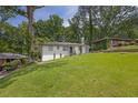 Well-kept single-story home with a lush front yard, and beautiful dark shingled roof at 2636 Flagstone Se Dr, Atlanta, GA 30316