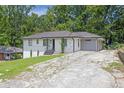 Charming ranch home with a paved driveway and beautiful yard at 2636 Flagstone Se Dr, Atlanta, GA 30316