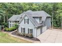 Rear view of beautiful home featuring gray siding, an attached garage, and a wrap-around patio at 3860 Overlake Dr, Cumming, GA 30041