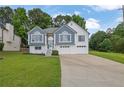 Charming two-story home with a well-manicured lawn, a two-car garage, and a welcoming front entrance at 4735 Julian Way, Acworth, GA 30101
