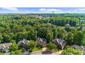 Beautiful aerial view showcasing the neighborhood surrounded by mature trees and lush greenery at 7049 Bennington Ln, Cumming, GA 30041