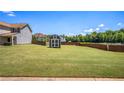Expansive backyard featuring a level lawn, storage shed, and wooden fence, ideal for outdoor activities at 1932 Sawgrass Dr, Hampton, GA 30228