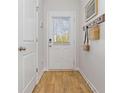 Inviting entryway with wood-look flooring, coat hooks, and a door with window at 227 Ivey Ter, Temple, GA 30179