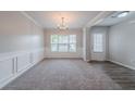 Bright dining room featuring neutral paint, carpet flooring, and natural light from a large window at 2557 Woodford Ln, Buford, GA 30519
