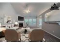 Cozy living room featuring a fireplace, neutral walls, plush carpeting, and ample natural light at 2557 Woodford Ln, Buford, GA 30519