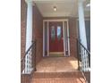 Close-up of the front door showcasing the elegant design, sidelights, decorative columns, and covered porch at 1669 Azalea Dr, Lawrenceville, GA 30043