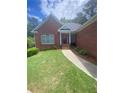 Inviting front entrance with brick facade, landscaped garden, and a covered porch leading to the front door at 1669 Azalea Dr, Lawrenceville, GA 30043