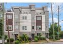 Contemporary townhouse featuring a rooftop deck and balconies, complemented by tidy landscaping and neutral tones at 1672 Dekalb Ne Ave # 2, Atlanta, GA 30307