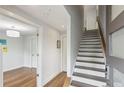 Hallway with hardwood floors, white trim, and an open doorway leading into another living space at 1672 Dekalb Ne Ave # 2, Atlanta, GA 30307