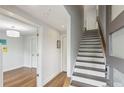 Hallway featuring hardwood floors, a staircase, and an open doorway leading to the living area at 1672 Dekalb Ne Ave # 2, Atlanta, GA 30307