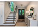Bright entryway featuring a staircase, black double doors and a stylish console table at 270 Shady Marsh Trl, Roswell, GA 30075