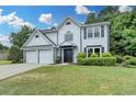 Charming two-story home with a well-manicured lawn, two-car garage, and inviting entrance at 3668 Burel Mill Dr, Buford, GA 30519