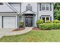 Close-up of a charming two-story home featuring a well-manicured lawn and inviting entrance at 3668 Burel Mill Dr, Buford, GA 30519