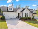 Beautifully landscaped front yard and a two-car garage at 5121 Aster Bnd, Canton, GA 30114