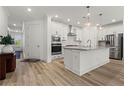 Modern kitchen features stainless steel appliances, granite countertops, and a center island at 5121 Aster Bnd, Canton, GA 30114