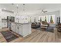 Open-concept kitchen and living area with hardwood floors and lots of natural light at 5121 Aster Bnd, Canton, GA 30114
