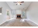 Spacious living room with a cozy brick fireplace and large windows at 7074 Springgrove Ct, Austell, GA 30168