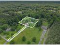 Aerial view of a property with lush greenery and wooded surroundings, showing privacy and ample space at 105 Tranquility Dr, Villa Rica, GA 30180