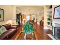 Open living room and dining area with hardwood floors, fireplace and view of the kitchen at 1203 Glenridge Ne Pl, Atlanta, GA 30342