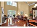 Bright living room featuring tall ceilings, hardwood floors, fireplace and French doors to deck at 1203 Glenridge Ne Pl, Atlanta, GA 30342