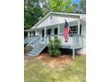 Charming home featuring front porch with American flag waving, creating a patriotic welcome at 175 Smith Ferguson Rd, Dallas, GA 30157