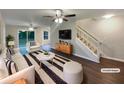 Bright living room features modern decor, dark wood floors, and a staircase to the second floor at 3508 Sweetgum Ln, Decatur, GA 30032
