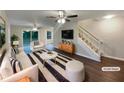 Bright living room with modern furniture, dark floors, and a staircase leading to the upper level at 3508 Sweetgum Ln, Decatur, GA 30032