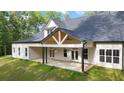 Expansive outdoor living space with a large patio and a covered porch at 5567 Tyree Rd, Winston, GA 30187